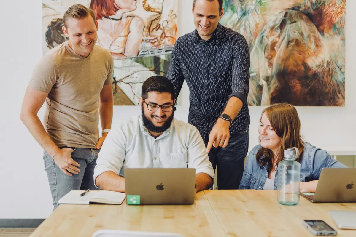 Team working together around a laptop